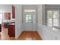 Bright foyer with hardwood flooring, decorative molding, and a glass-paneled front door at 103 Aisling Ct, Cary, NC 27513