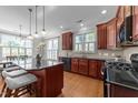 Spacious kitchen with a large island, dark countertops, ample cabinet storage, and natural lighting at 103 Aisling Ct, Cary, NC 27513
