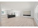 Bright and airy living room featuring wood-look floors, modern lighting, and an open layout at 1065 Shuford Rd, Wake Forest, NC 27587