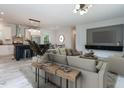 Open-concept living room with modern lighting, stylish decor, and seamless flow to the kitchen at 1065 Shuford Rd, Wake Forest, NC 27587