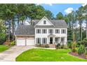 Charming two-story home with a manicured lawn and a two-car garage at 1120 Colonial Club Rd, Wake Forest, NC 27587