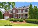 Beautiful brick home with manicured landscaping and a two car garage at 1153 Litchborough Way, Wake Forest, NC 27587