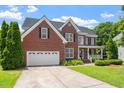 Picture of a brick two-story home with a two-car garage and green lawn at 1153 Litchborough Way, Wake Forest, NC 27587
