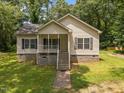 Charming single-Gathering home featuring a welcoming front porch, well-maintained lawn, and classic siding at 116 Justice St, Chapel Hill, NC 27516