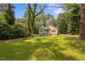 Nestled amongst mature trees, this home has a beautiful lawn and front yard at 116 Justice St, Chapel Hill, NC 27516