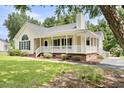Lovely single-story home featuring a wraparound porch and manicured landscaping at 117 S Woodstone Dr, Archer Lodge, NC 27527