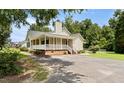 Delightful single-story home with a generous wraparound porch, ideal for relaxing outdoors at 117 S Woodstone Dr, Archer Lodge, NC 27527