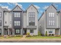 Modern gray townhome with neat landscaping and a welcoming entrance at 1172 Cottonsprings Dr, Wendell, NC 27591