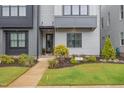 Well-maintained front lawn and entrance of townhome with tidy landscaping at 1172 Cottonsprings Dr, Wendell, NC 27591