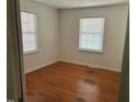 Bright bedroom with hardwood flooring, neutral walls and featuring two windows to allow for plenty of natural light at 1225 Fairlane Rd, Cary, NC 27511