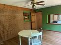 Dining area featuring brick wall, window, and light wood-look flooring at 1225 Fairlane Rd, Cary, NC 27511