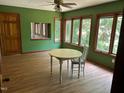 Bright dining room with large windows, wood trim, and ceiling fan at 1225 Fairlane Rd, Cary, NC 27511