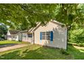 A view from the side of the house showing the manicured lawn and blue shutters on the home at 1261 Grovewood Dr, Clayton, NC 27520
