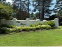 Welcoming community sign amidst lush greenery and landscaped flower beds at 133 Black Cloud Dr, Louisburg, NC 27549