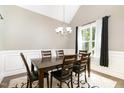 Elegant dining room featuring a wooden table, six chairs, and a stylish chandelier at 14 Water Front Ln, Timberlake, NC 27583