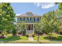 Charming two-story home with inviting front porch, manicured landscaping and stairway leading to the front door at 149 N Serenity Hill Cir, Chapel Hill, NC 27516