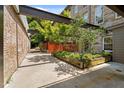 Outdoor patio showcasing modern design with stone and brick walls and lush landscaping at 1500 River Mill Dr # 101, Wake Forest, NC 27587