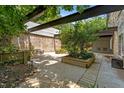 Outdoor patio with wood beam pergola and planters, offering a tranquil setting at 1500 River Mill Dr # 101, Wake Forest, NC 27587