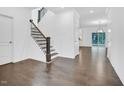 Bright entryway showcases beautiful hardwood floors and a staircase to the upper level at 1505 Willow Landing Way, Willow Springs, NC 27592