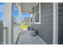 Covered front porch offers a cozy spot to relax and enjoy the neighborhood views at 1505 Willow Landing Way, Willow Springs, NC 27592