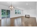 Spacious living room features hardwood floors, ample natural light, and access to the screened-in porch at 1505 Willow Landing Way, Willow Springs, NC 27592