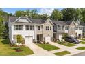 Charming townhomes with single-car garages, manicured lawns, and stone accents create an inviting curb appeal at 156 Velvet Ridge Way, Garner, NC 27529