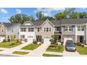 Charming townhomes with single-car garages, manicured lawns, and stone accents create an inviting curb appeal at 156 Velvet Ridge Way, Garner, NC 27529