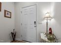 Bright entryway featuring a white front door, neutral walls, and stylish decor at 1891 Frost Dr, Haw River, NC 27258