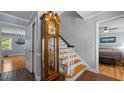 Inviting entryway featuring a grandfather clock, staircase, and terracotta tile flooring at 1926 Downing Dr, Burlington, NC 27215