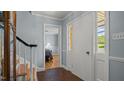 Hallway showcasing neutral paint and trim, as well as terracotta tile flooring and natural light at 1926 Downing Dr, Burlington, NC 27215