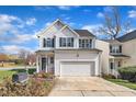 Traditional two-story home featuring an attached garage, white siding, green shutters, and a well-kept front yard at 1968 Shadow Glen Dr, Raleigh, NC 27604