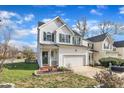 Exterior view of a well-maintained home with a green front door, complemented by mature landscaping and a paved driveway at 1968 Shadow Glen Dr, Raleigh, NC 27604