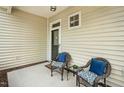 Cozy porch featuring wicker seating with blue pillows, perfect for relaxing outdoors at 2000 Silky Dogwood Trail Trl, Apex, NC 27502