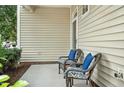 Cozy porch featuring wicker seating with blue pillows, perfect for relaxing outdoors at 2000 Silky Dogwood Trail Trl, Apex, NC 27502