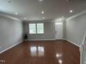 Spacious, light-filled living room with hardwood floors, white trim, and a view of the front yard at 205 Bog Hill Ln, Cary, NC 27519