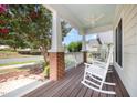 Relaxing covered front porch with rocking chairs and a ceiling fan at 209 Homegate Cir, Apex, NC 27502