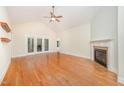 Bright living room with hardwood floors, fireplace, and access to the backyard at 209 Homegate Cir, Apex, NC 27502