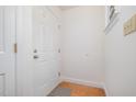 Bright entryway featuring a white door, hardwood floors, and classic trim at 2213 Alpine Rd, Durham, NC 27707