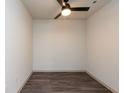 A simple bedroom with wood floors, a ceiling fan, and natural light at 2323 Gathering Sq Ct, Fuquay Varina, NC 27526