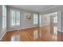Spacious living room featuring hardwood floors, plantation shutters, and decorative trim at 2420 Rogerson St, Raleigh, NC 27614