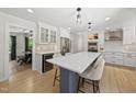 Open concept kitchen with white cabinets, stainless steel appliances, and an island with seating for three at 2704 Farnborough Rd, Raleigh, NC 27613