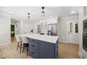 Spacious kitchen with a large island featuring a white countertop and stainless steel appliances, perfect for entertaining at 2704 Farnborough Rd, Raleigh, NC 27613