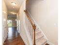Bright entryway featuring a staircase with carpeted steps and wooden handrail at 2808 Carter Finley Pl, Raleigh, NC 27606