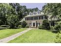 An attractive brick home with dark shutters and manicured landscaping sits on a lush lawn at 3112 Lake Pointe Trl, Rocky Mount, NC 27804
