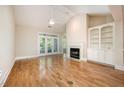 Spacious living room featuring a fireplace, built-in shelving, and a ceiling fan at 3701 Baron Cooper Pass # 303, Raleigh, NC 27612