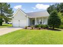 Charming single-story home with a well-manicured lawn, two-car garage, and inviting front porch at 4111 Branchwood Dr, Durham, NC 27705