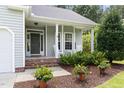 Inviting front porch with rocking chairs and well-maintained landscaping around the home's entrance at 4111 Branchwood Dr, Durham, NC 27705