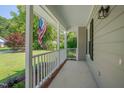 Spacious covered front porch with a white railing, perfect for relaxing at 4140 Willow Haven Ct, Raleigh, NC 27616