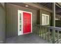 Close-up of the inviting red front door with sidelight, and painted exterior at 4403 Sunburst Ct, Raleigh, NC 27613