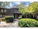 Inviting two-story townhome with a red front door, balcony, and lush greenery at 4403 Sunburst Ct, Raleigh, NC 27613